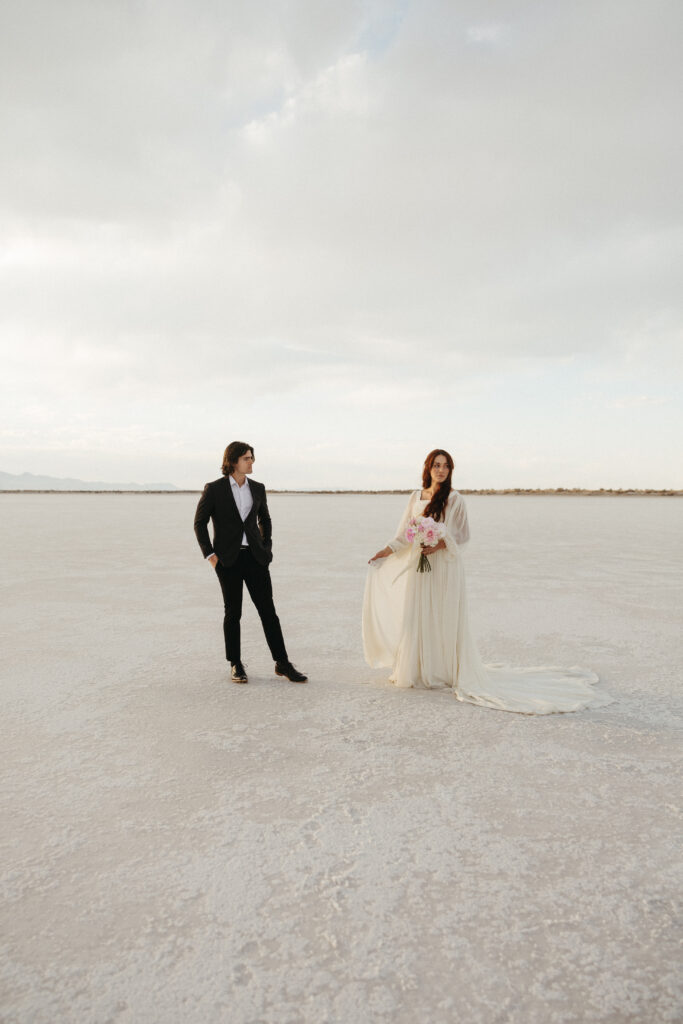 Bride and groom share a glance after eloping at Bonneville Salt Flats in Utah.