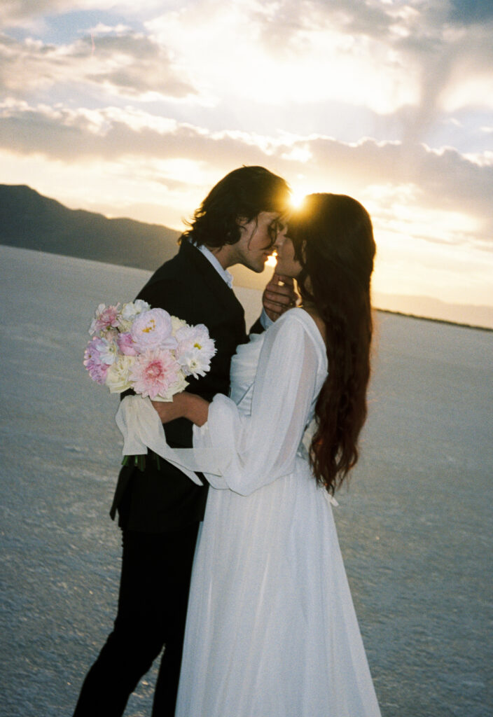 Film photography of bride and groom during elopement at golden hour at Bonneville Salt Flats in Utah.